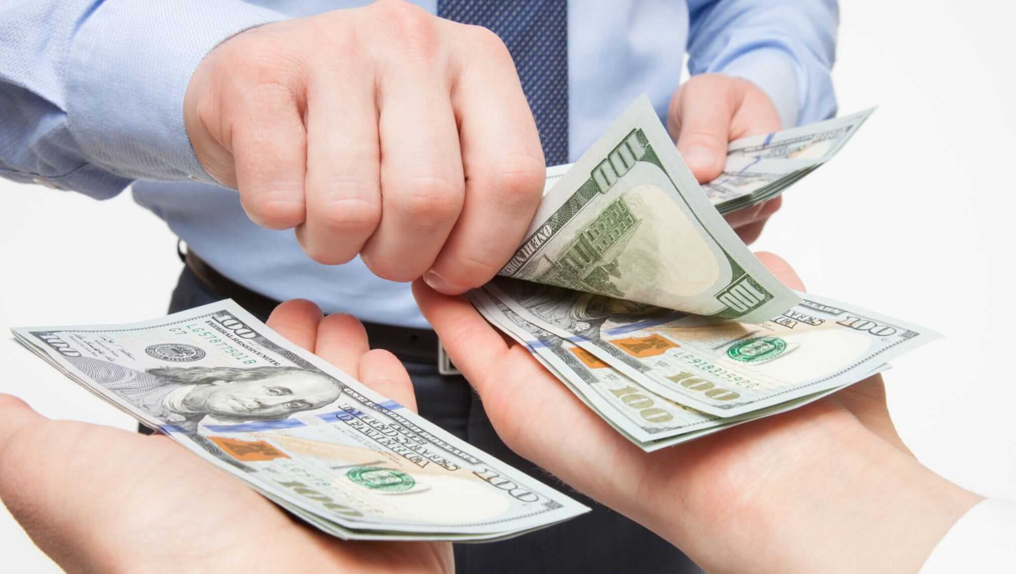 a person holding money in their hands