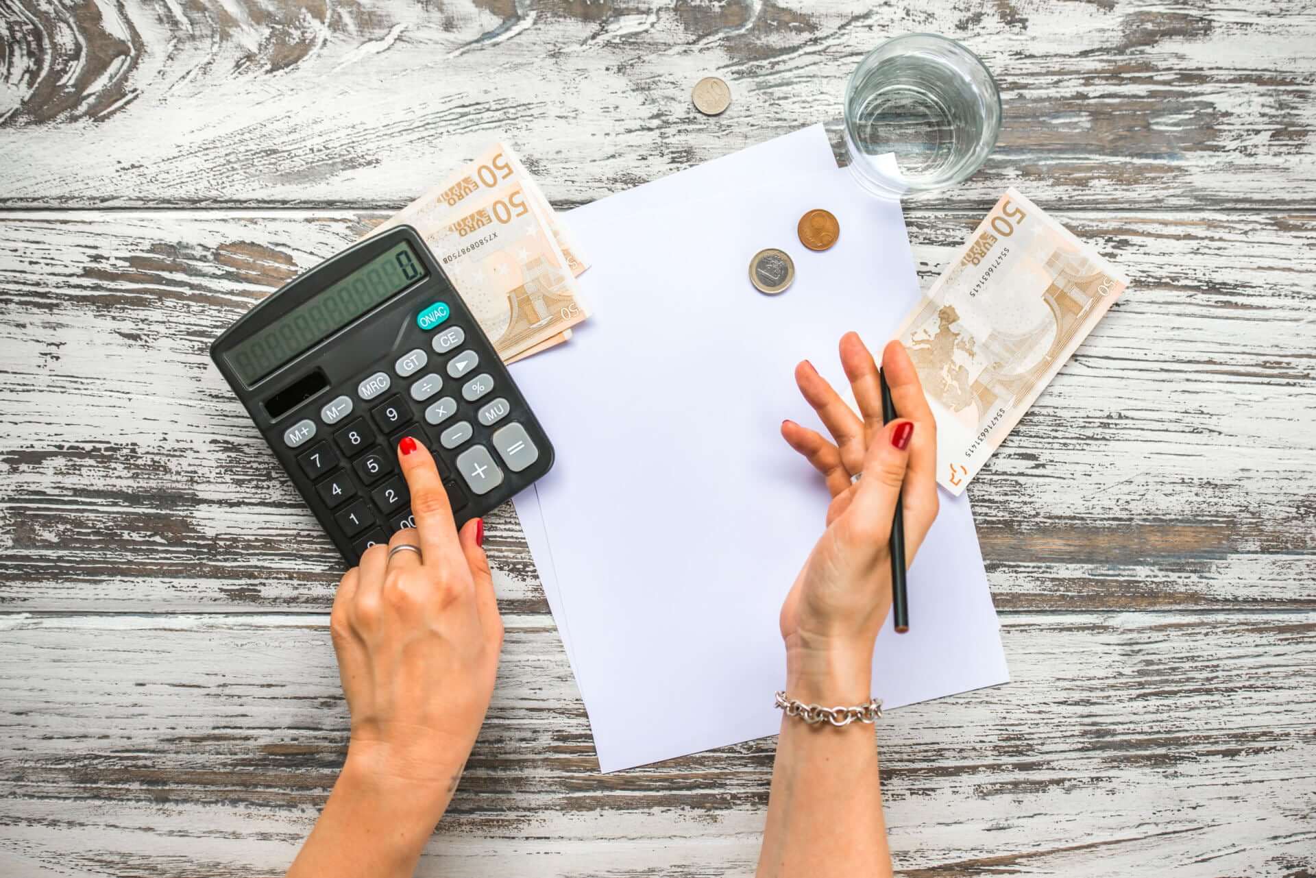 a person using a calculator and a pen