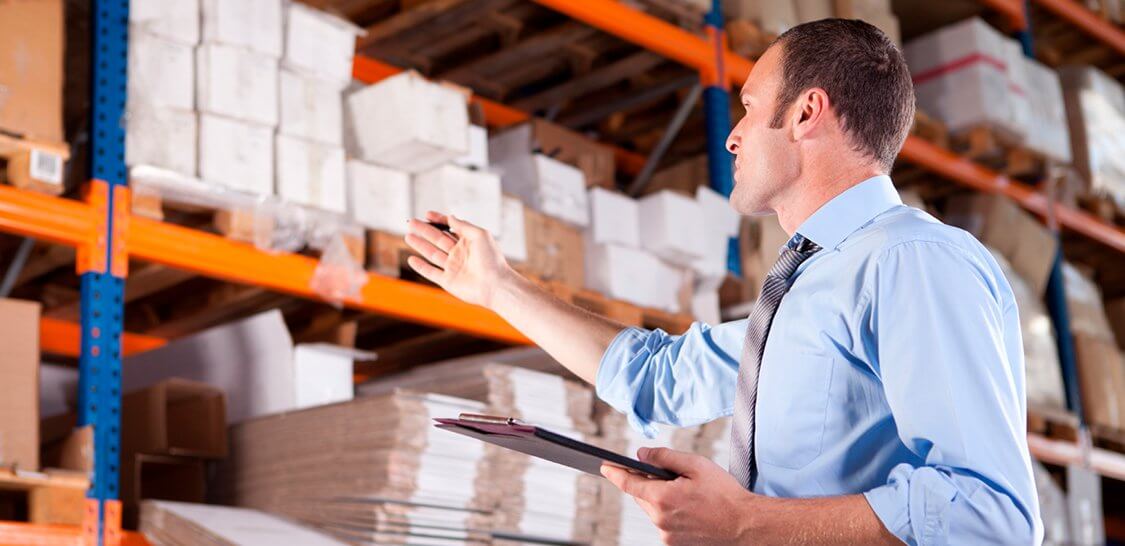 a man holding a clipboard and pointing at something